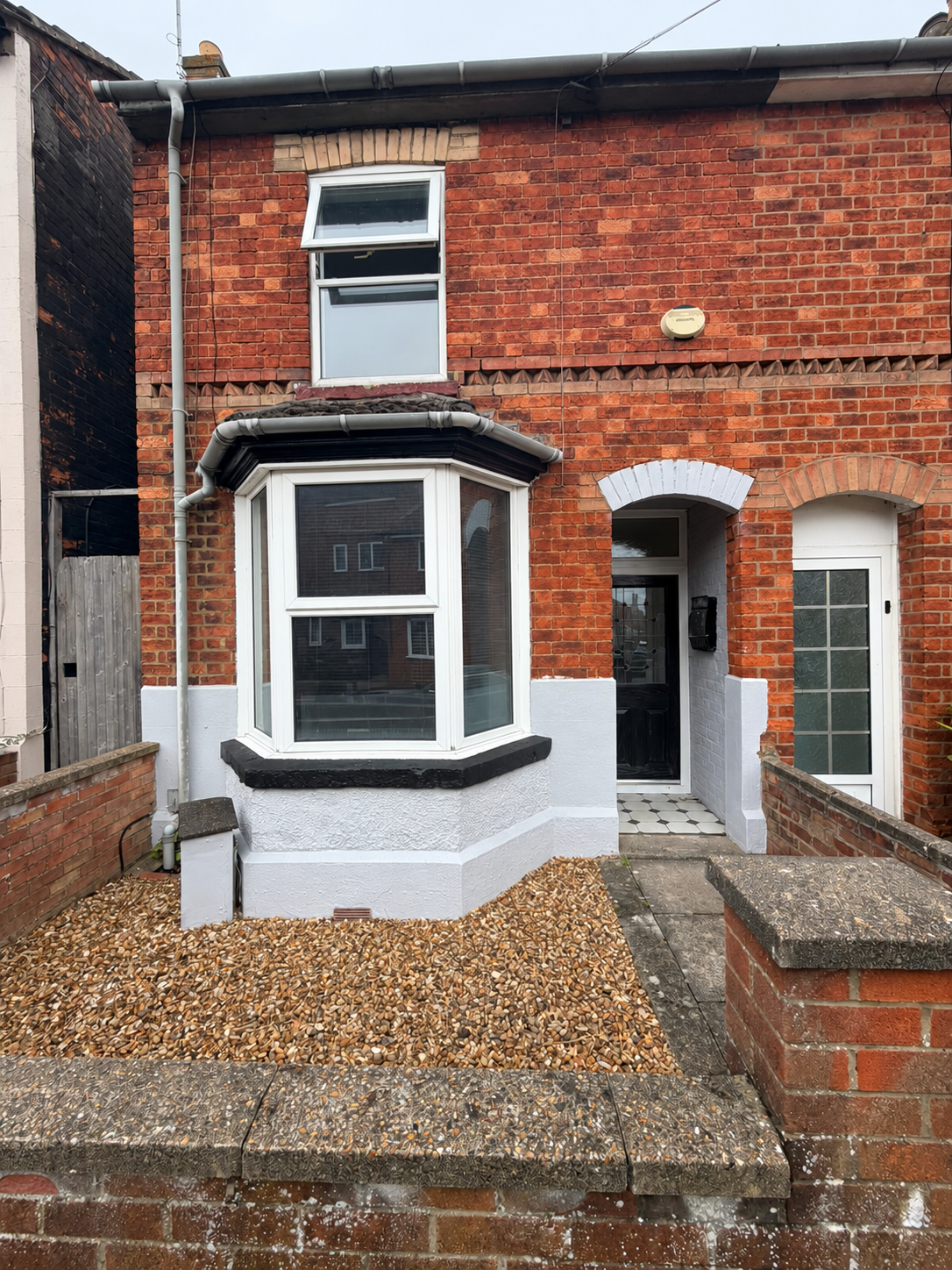 Brick exterior of our 2026 Rushden investment, with a white bay window and gravel front garden